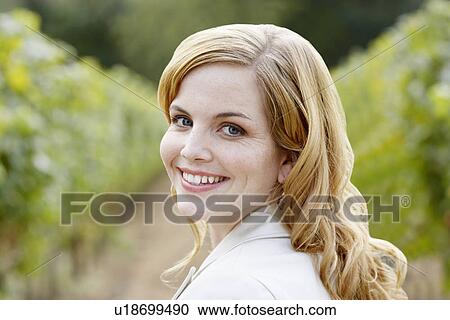 Stock Image - Young woman in vineyard (portrait). Fotosearch