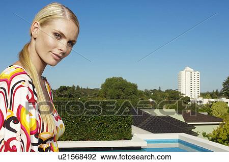 Young woman on balcony (portrait) View Large Photo Image Stock Image - Young woman on balcony (portrait). Fotosearch