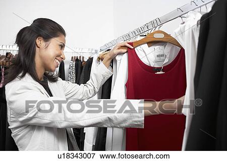 Young woman shopping clothes View Large Photo Image Stock Photo - Young woman shopping clothes. Fotosearch