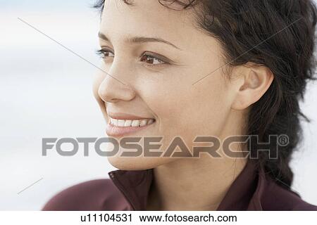 Stock Image - Young woman smiling (close-up). Fotosearch
