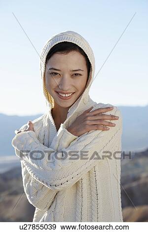 Stock Photo - Young woman wearing hood (portrait). Fotosearch
