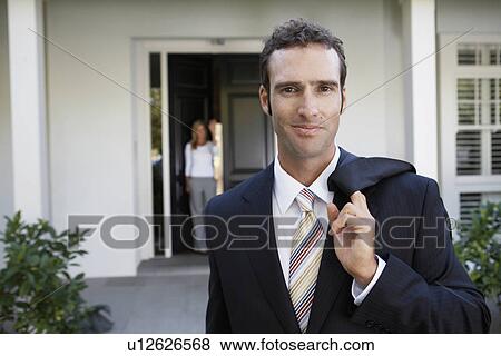 Businessman leaving for work, wife at door View Large Photo Image Stock Photo - Businessman leaving for work, wife at door. Fotosearch