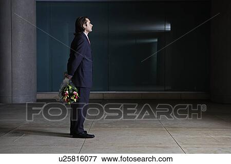 Businessman Standing with Bunch of Flowers Behind Back View Large Photo Image Stock Photo - Businessman Standing with Bunch of Flowers Behind Back. Fotosearch