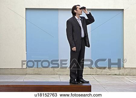 Stock Image - Businessman Using Binoculars. Fotosearch
