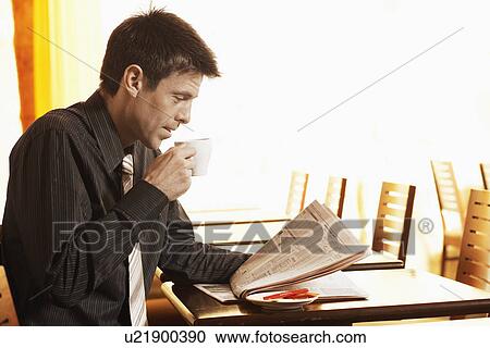 Mid adult businessman drinking coffee and reading newspaper View Large Photo Image Stock Image - Mid adult businessman drinking coffee and reading newspaper. Fotosearch