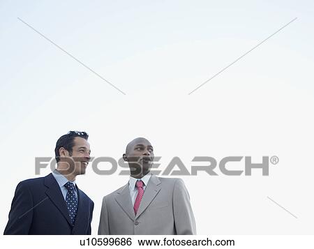Two businessmen (low angle view) View Large Photo Image Stock Photograph - Two businessmen (low angle view). Fotosearch