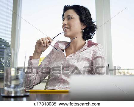 Stock Photography - Businesswoman in meeting (low angle view). Fotosearch
