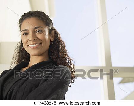 Businesswoman smiling (portrait, low angle view) View Large Photo Image Stock Photo - Businesswoman smiling (portrait, low angle view). Fotosearch