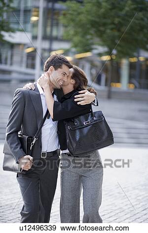 Couple hugging at public square View Large Photo Image Stock Photo - Couple hugging at public square. Fotosearch