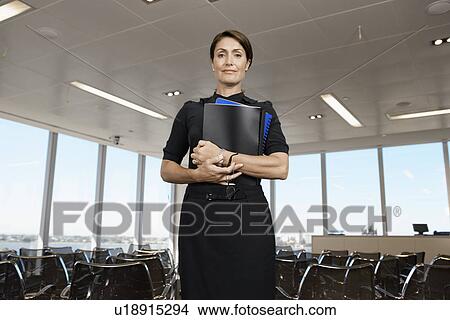 Picture - Mature woman in lecture theater (portrait, low angle view). Fotosearch