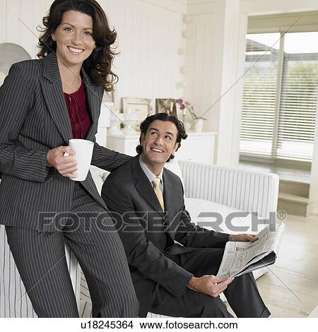 Picture - Mid adult couple in living room. Fotosearch