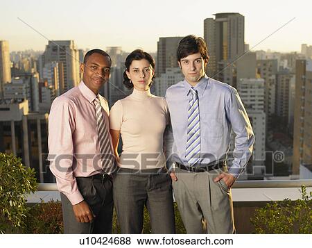 Stock Photo - Three businesspeople on balcony (portrait), Sao Paolo, Brazil. Fotosearch