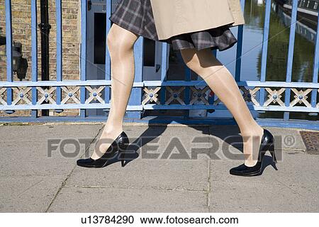 Woman walking on bridge (close-up) View Large Photo Image Stock Image - Woman walking on bridge (close-up). Fotosearch