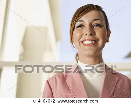 Stock Image - Young businesswoman laughing (portrait). Fotosearch