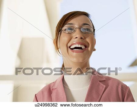 Stock Image - Young businesswoman laughing (portrait). Fotosearch