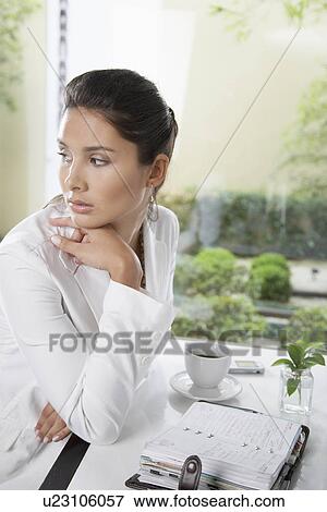 Young woman with organizer at coffee table View Large Photo Image Stock Photo - Young woman with organizer at coffee table. Fotosearch