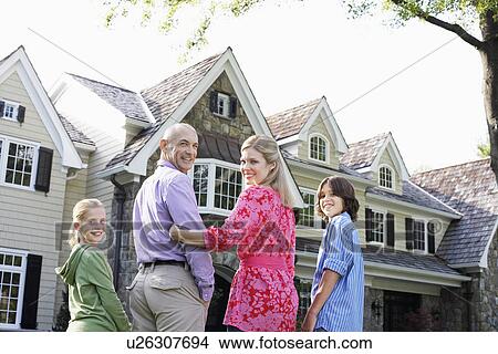 Picture - Family with two children near house, Chatham, New Jersey, USA. Fotosearch