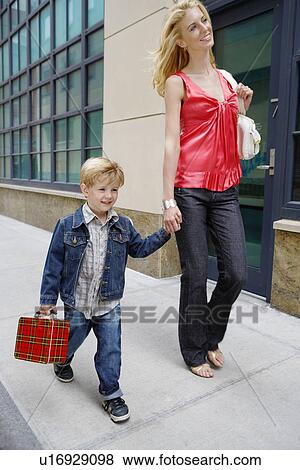 Stock Photo - Mother and son walking on sidewalk. Fotosearch