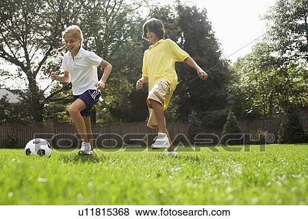 Sister and brother playing soccer View Large Photo Image Stock Photo - Sister and brother playing soccer. Fotosearch