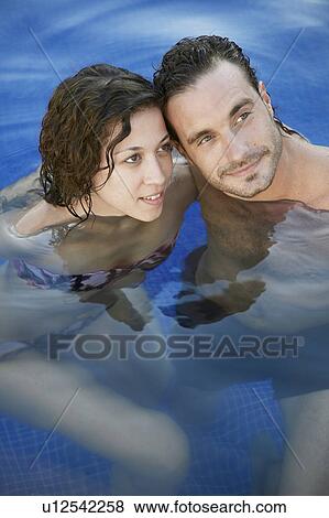 Mid adult couple in water (portrait, high angle view) View Large Photo Image Stock Photo - Mid adult couple in water (portrait, high angle view). Fotosearch