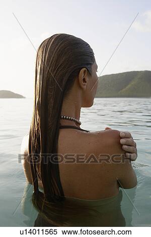 Mid adult woman standing in ocean (rear view), St. John, US Virgin Islands, USA View Large Photo Image Stock Photography - Mid adult woman standing in ocean (rear view), St. John, US Virgin Islands, USA. Fotosearch