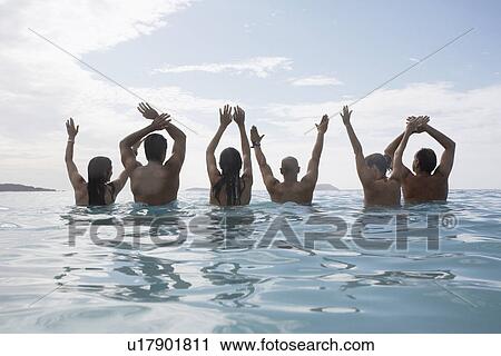 Six people raising hands in sea, St. John, US Virgin Islands, USA View Large Photo Image Stock Image - Six people raising hands in sea, St. John, US Virgin Islands, USA. Fotosearch