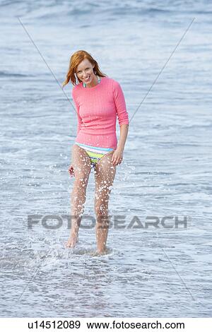 Woman walking in water View Large Photo Image Stock Photo - Woman walking in water. Fotosearch