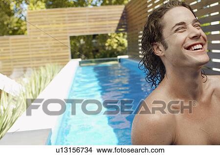 Young man by swimming pool View Large Photo Image Picture - Young man by swimming pool. Fotosearch