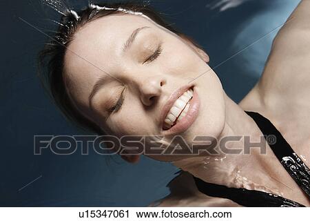 Young woman floating on water (directly above) View Large Photo Image Stock Image - Young woman floating on water (directly above). Fotosearch