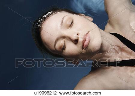 Young woman floating on water (directly above) View Large Photo Image Stock Image - Young woman floating on water (directly above). Fotosearch