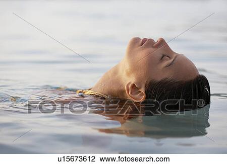 Young woman swimming View Large Photo Image Stock Image - Young woman swimming. Fotosearch