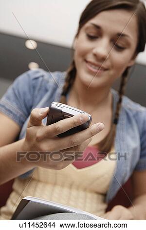College student using PDA View Large Photo Image Picture - College student using PDA. Fotosearch
