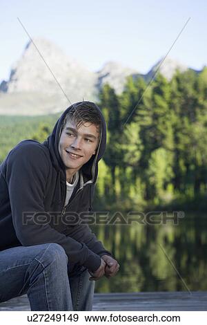 Teenage boy by lake, Cape Town, South Africa View Large Photo Image Stock Photo - Teenage boy by lake, Cape Town, South Africa. Fotosearch