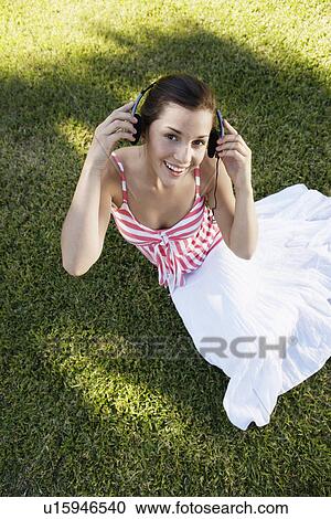 Teenage girl listening to headphones (portrait, high angle view) View Large Photo Image Stock Image - Teenage girl listening to headphones (portrait, high angle view). Fotosearch