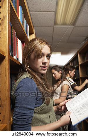 Three female students in library View Large Photo Image Picture - Three female students in library. Fotosearch