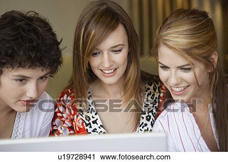 Three teenage girls using laptop View Large Photo Image Stock Image - Three teenage girls using laptop. Fotosearch