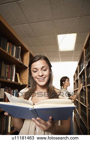 Two female students in library View Large Photo Image Stock Image - Two female students in library. Fotosearch