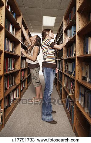 Two female students in library View Large Photo Image Stock Image - Two female students in library. Fotosearch