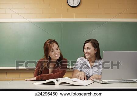 Stock Image - Two students studying in classroom. Fotosearch