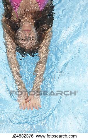 M id adult woman diving (directly above) View Large Photo Image Stock Photograph - M id adult woman diving (directly above). Fotosearch