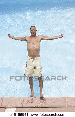 Mid adult man falling backwards into pool (directly above) View Large Photo Image Stock Image - Mid adult man falling backwards into pool (directly above). Fotosearch