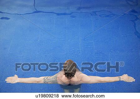Mid adult man in water, arms outstretched (rear view, high angle view) View Large Photo Image Stock Photo - Mid adult man in water, arms outstretched (rear view, high angle view). Fotosearch