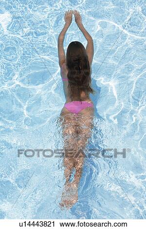 Mid adult woman diving in swimming pool (high angle view) View Large Photo Image Stock Image - Mid adult woman diving in swimming pool (high angle view). Fotosearch