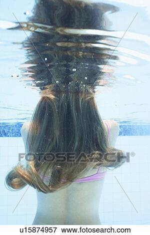 Stock Photo - Mid adult woman diving (underwater view). Fotosearch