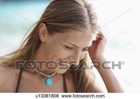 Stock Photo - Mid adult woman looking down. Fotosearch