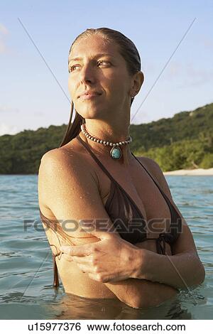 Mid adult woman standing in ocean, St. John, US Virgin Islands, USA View Large Photo Image Stock Photograph - Mid adult woman standing in ocean, St. John, US Virgin Islands, USA. Fotosearch