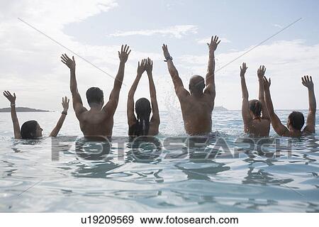 Six people raising hands in sea, St. John, US Virgin Islands, USA View Large Photo Image Stock Photo - Six people raising hands in sea, St. John, US Virgin Islands, USA. Fotosearch