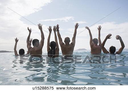 Six people raising hands in sea, St. John, US Virgin Islands, USA View Large Photo Image Stock Photography - Six people raising hands in sea, St. John, US Virgin Islands, USA. Fotosearch