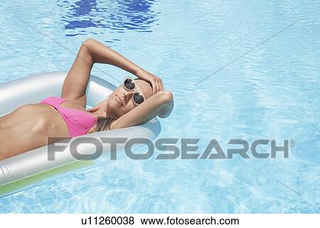 Woman lying on pool raft View Large Photo Image Stock Photo - Woman lying on pool raft. Fotosearch