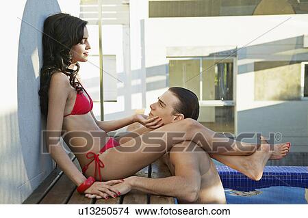 Young Couple Flirting at Poolside View Large Photo Image Picture - Young Couple Flirting at Poolside. Fotosearch